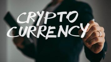 man holds pen or marker and writing Cryptocurrency word