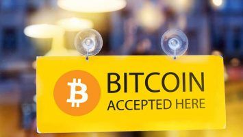 Bitcoins accepted here - logo of bitcoin on restaurant glass door (1)