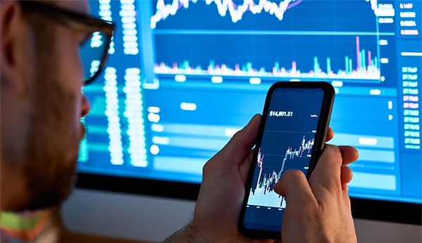 an image with person using smartphone app for cryptocurrency stock market  